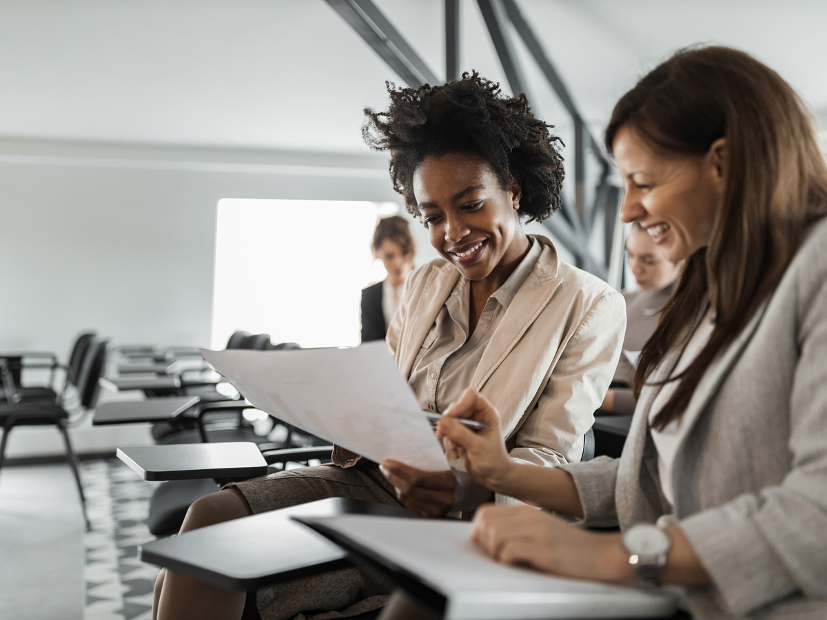 two-female-suits-doing-paperwork